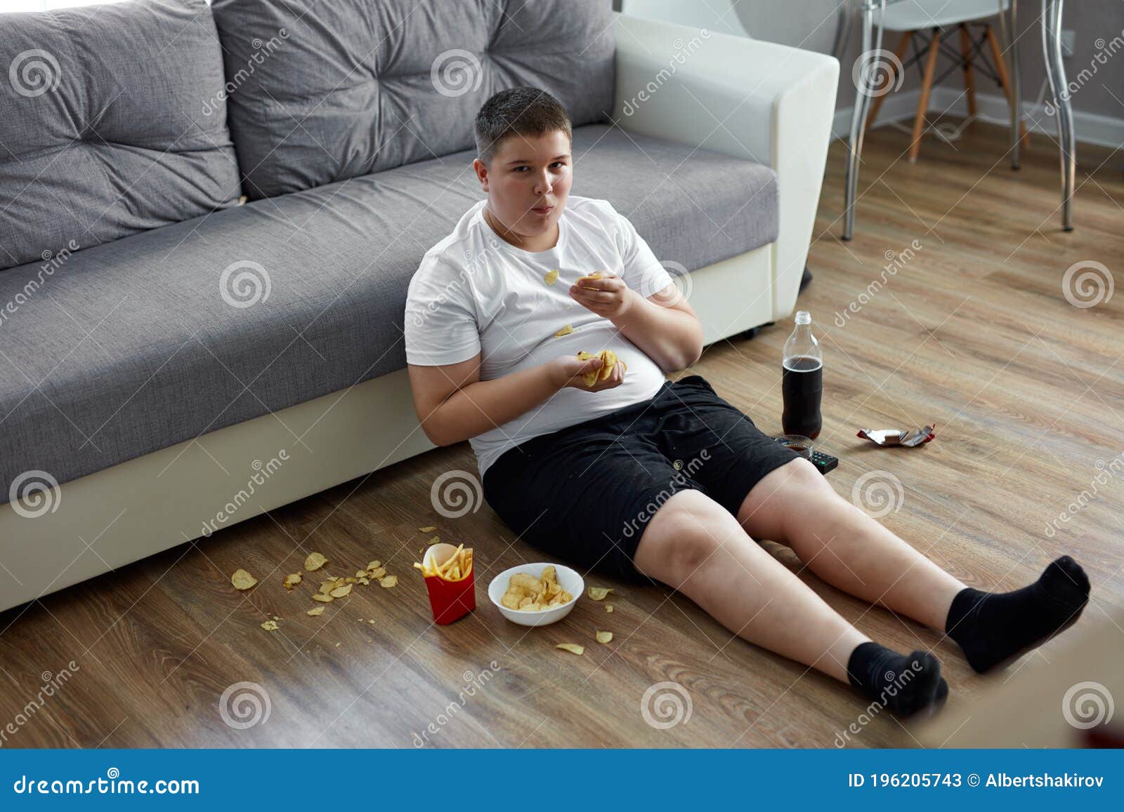overweight-fat-boy-eat-junk-food-watching-tv-alone-home-overweight-fat-boy-eat-junk-food-watching-tv-alone-home-196205743.jpg
