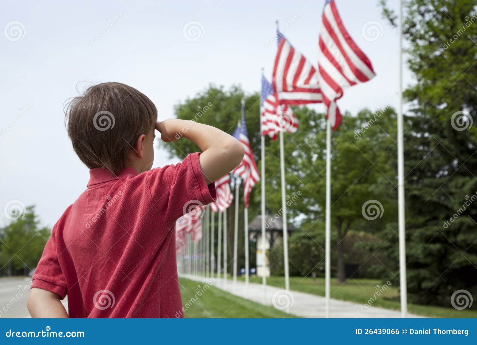 young-boy-saluting-american-flags-memorial-day-26439066.jpg